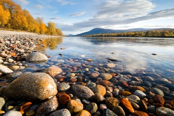 Autumn landscape by the river spey with colorful riverbank stones and scenic mountain view