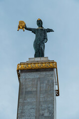 Monument statue on pedestal in city square