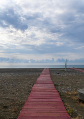 Country path across open field under clouds, Netherlands, 2025