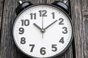 Vintage Alarm Clock on Weathered Wooden Surface Reflecting Time and Nostalgia