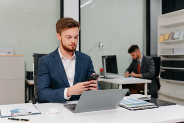 Business man working at office with laptop and documents on desk, financial adviser analyzing data.
