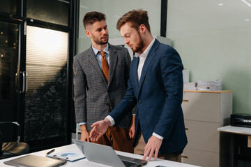 Diverse professionals collaborate on project analysis with financial graphs.