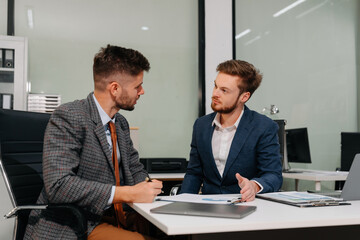 Diverse professionals collaborate on project analysis with financial graphs.