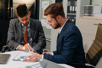 Diverse professionals collaborate on project analysis with financial graphs.