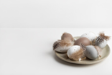 Plate with decorative eggs in natural earth colours. Happy Easter concept, copy space for your text.