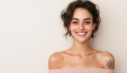 Obraz premium Smiling woman with curly hair wearing an off-shoulder top against a light background.
