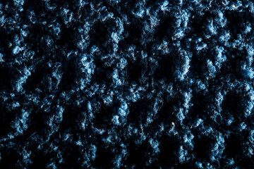 Macro close-up of blue wool fabric revealing intricate texture