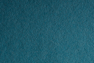 Macro close-up of dark teal textured paper surface for background