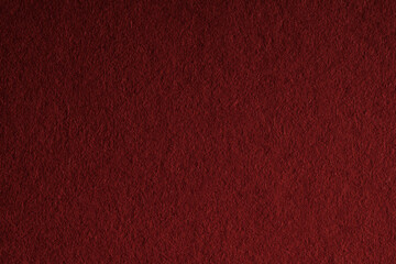 Macro close-up of dark red felt material filling the frame