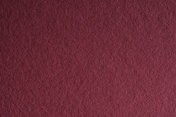 Macro close-up of dark red felt or fabric texture background