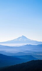 Fototapeta premium Mount Hood in Oregon, USA, Snow-Capped Summit, Layered Mountain Ranges and Forest Under Clear Blue Sky