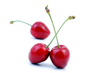 Cherry. Three red cherries isolated on white background.