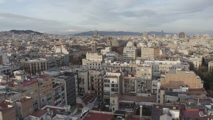 Fototapeta premium Panoramic bird's-eye view of Barcelona. Drone movement from residential areas to the Sagrada Familia Cathedral