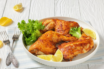 baked in oven three chicken leg quarters, top view