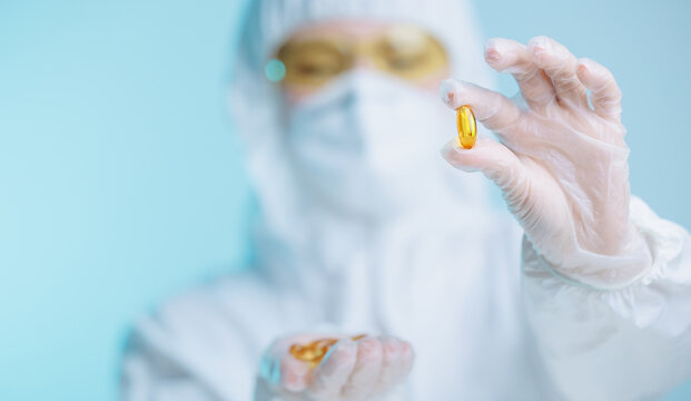 Medical production worker inspecting omega 3 capsules for quality assurance - Powered by Adobe
