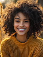 Bright smile of a young woman in autumn landscape