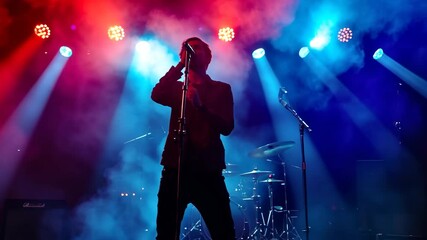 Energetic live performance by the band at a vibrant music venue filled with colorful lights