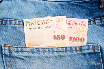 Bermudian dollar in the pocket of blue jeans