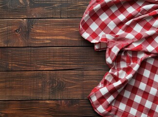 Red checkered tablecloth on rustic wooden background, perfect for cozy dining and inviting atmospheres.