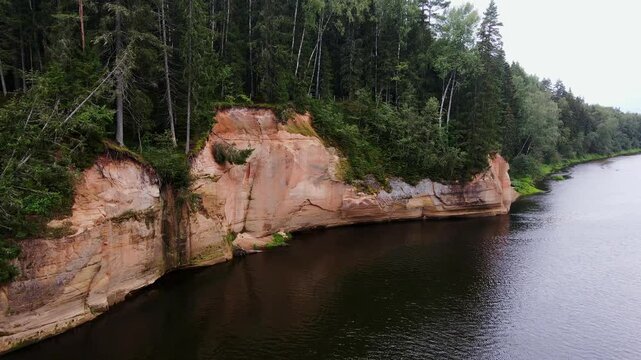 Ērgļu sandstone Cliffs, cliffs in Gauja National Park, Latvia forest, Drone, 4K