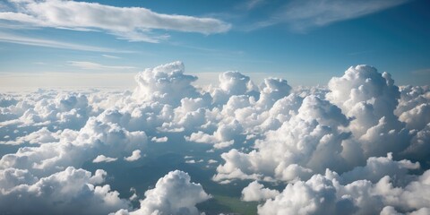 Fototapeta premium Aerial view of fluffy white cumulus clouds against a clear blue sky during daytime with soft sunlight illuminating the scene