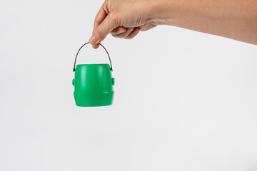 Halloween pumpkin-shaped plastic cup in hand, white background