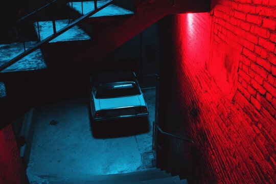 Dramatic urban scene with vintage car neon lights - Powered by Adobe