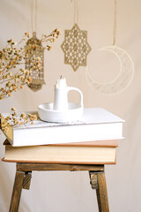 book, candle on wooden chair in ramadan concept