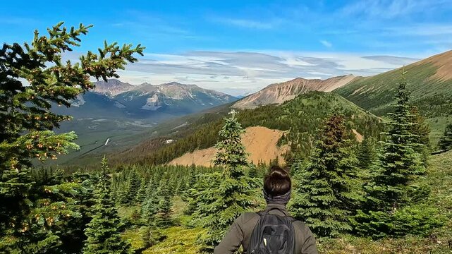 Slow-motion of Caucasian woman treks through the scenic Maligne Lake Trail in Jasper National Park