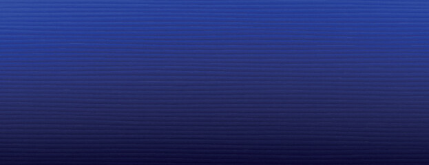 Obraz premium A blue background with a subtle striped texture. The background is deep blue, creating a calm and modern background style. Minimal line paper texture. Simple paper background vector