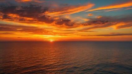 Obraz premium Vibrant Sunset Over Tranquil Water with Fiery Hues and Dynamic Cloud Patterns Creating a Stunning Natural Landscape Scene