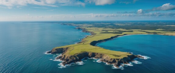 Fototapeta premium Aerial Panorama of Coastal Landscape Featuring Lush Greenery and Vibrant Blue Waters Under a Clear Sky
