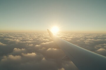 Sunrise illuminates fluffy clouds as airplane wing pierces sky,