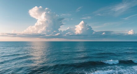 Obraz premium Serene Ocean Waves Under a Vivid Sky with Fluffy Clouds at Sunset