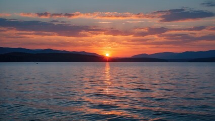Naklejka premium Tranquil Sunset Reflections Over Calm Lake with Long Exposure Technique and Rolling Hills in the Background