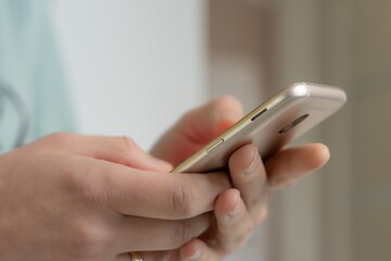 Close-up of hands holding a smartphone, digital communication concept