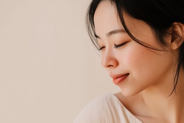 Fototapeta premium Young asian woman closing eyes and smiling serene expression wellness and skincare concept