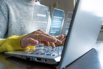 Hands typing on laptop with floating digital documents, concept of cloud storage and online file management