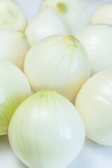 Fresh whole white onions on light background, organic food and healthy cooking
