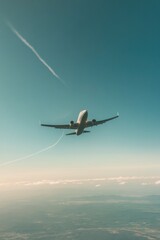 Airplane soaring through clear sky, leaving white trails behind,