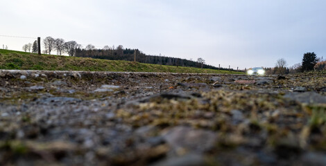 A calming view of a winding gravel path that meanders through a vibrant and lush landscape beneath...