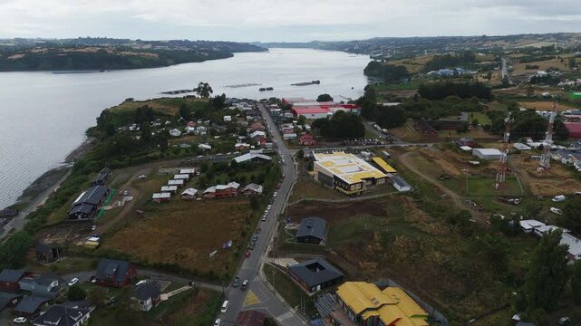 Chonchi is a Chilean town and commune located in the Los Lagos Region, on the island of Chiloe, showing buildings, roads and the bay in an aerial view