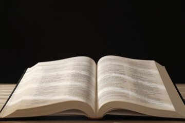 Fototapeta premium Open Holy Bible in English language on table, closeup