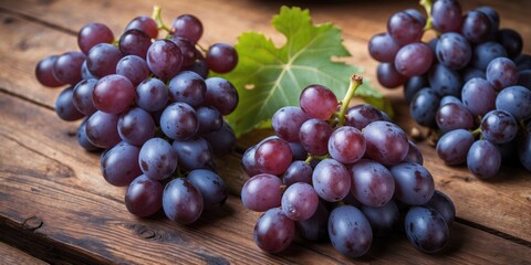 Obraz premium Fresh Juicy Grapes with Green Leaves on Rustic Wooden Table Ideal for Healthy Lifestyle and Food Related Designs