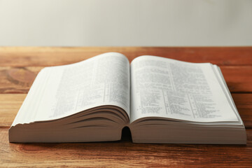 Obraz premium Open Holy Bible in English language on wooden table, closeup