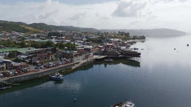 Aerial view of Dalcahue, Chiloe Island, Chile, featuring the waterfront, boats, and the characteristic palafitos