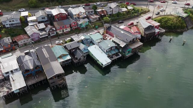 Aerial view of palafitos, traditional colorful wooden stilt houses, reflecting in the water in Castro, Chiloe Island, Chile