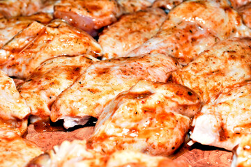 Close-up of chicken wings coated with marinade and spices. Ready to cook.