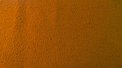 Fototapeta premium This is a close-up view of an orange fabric with a subtle, rough texture.