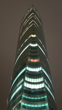 Tour Legend or EDF skyscraper illuminated at night, La D&eacute;fense, Paris in France. Vertical format, low-angle